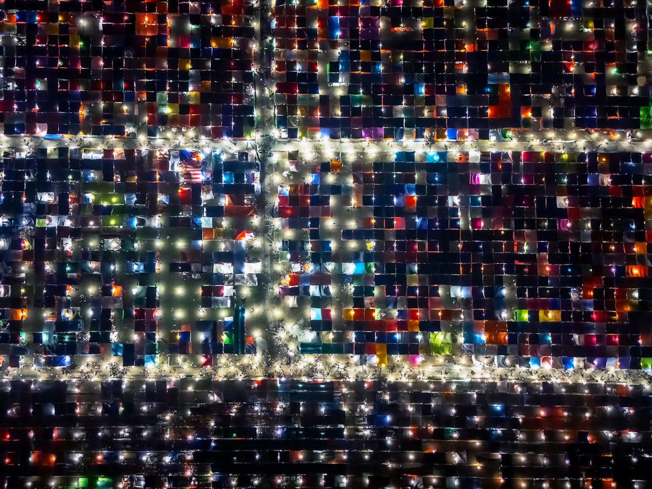 Vibrant aerial shot of a bustling night market in Dhaka, Bangladesh.